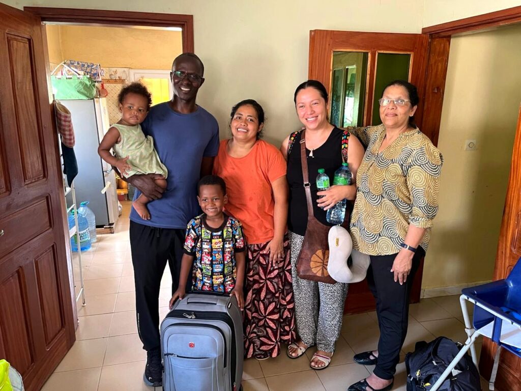 Mission team fellowship during a community home visit.